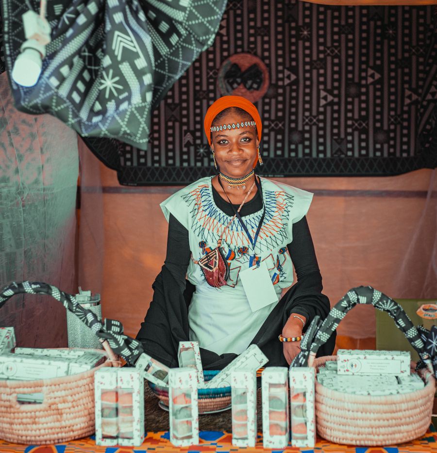 A textile and artisan-goods trader at her stall
