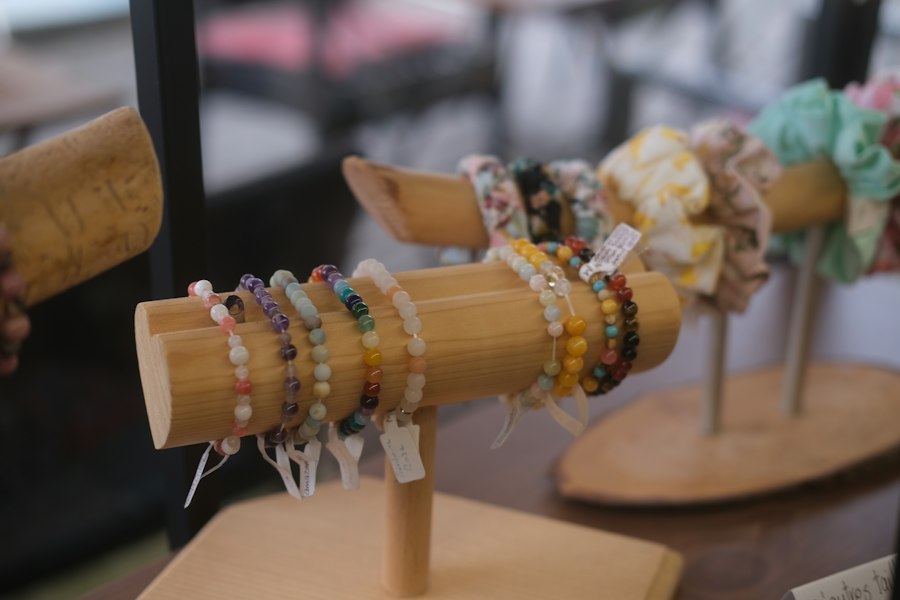 Colorful beaded bracelets and accessories on a market display stand