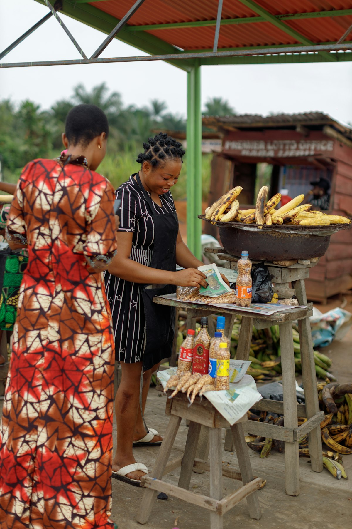 A vendor wrapping up a customer's order at a roadside stall